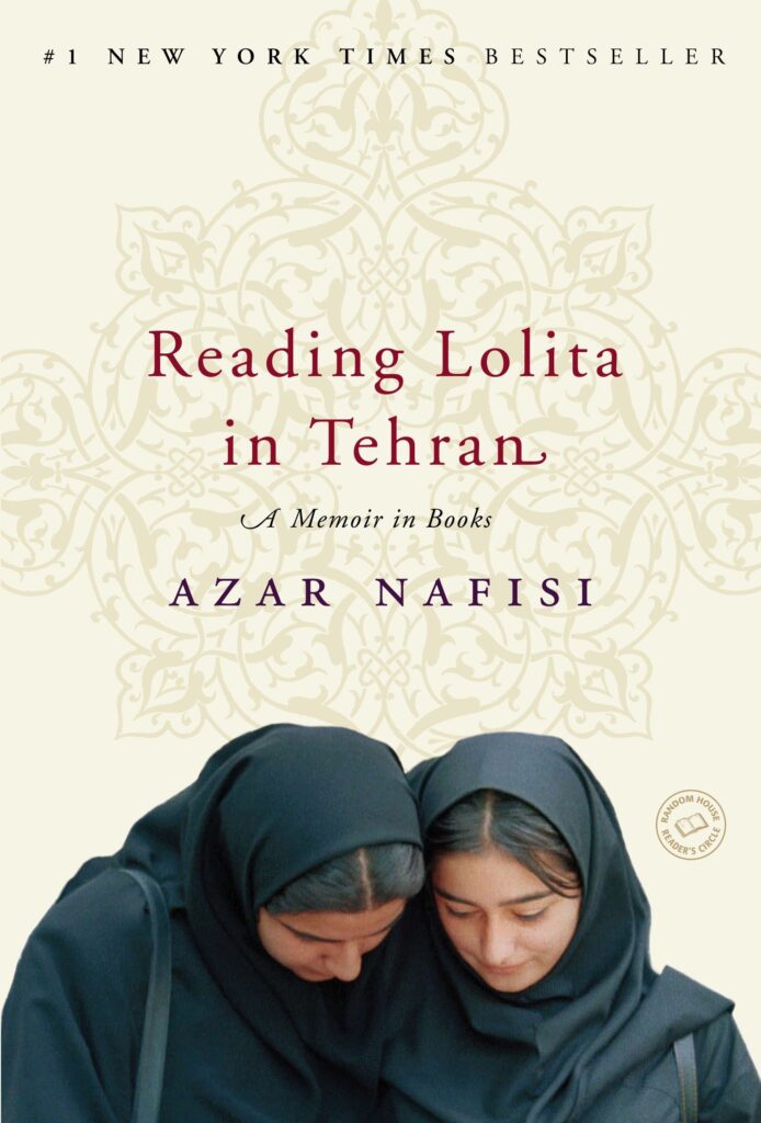 Cover of the book Reading Lolita in Tehran: A Memoir in Books by Azar Nafisi. The design features a cream background with an ornate, faded Persian floral pattern. At the bottom of the cover, two young women in black headscarves and cloaks are shown closely reading or looking down together. The title is printed in deep red serif font, with the author’s name in purple. A small circular emblem on the right indicates it is part of the Random House Reader’s Circle. At the top, the book is labeled a "#1 New York Times Bestseller.